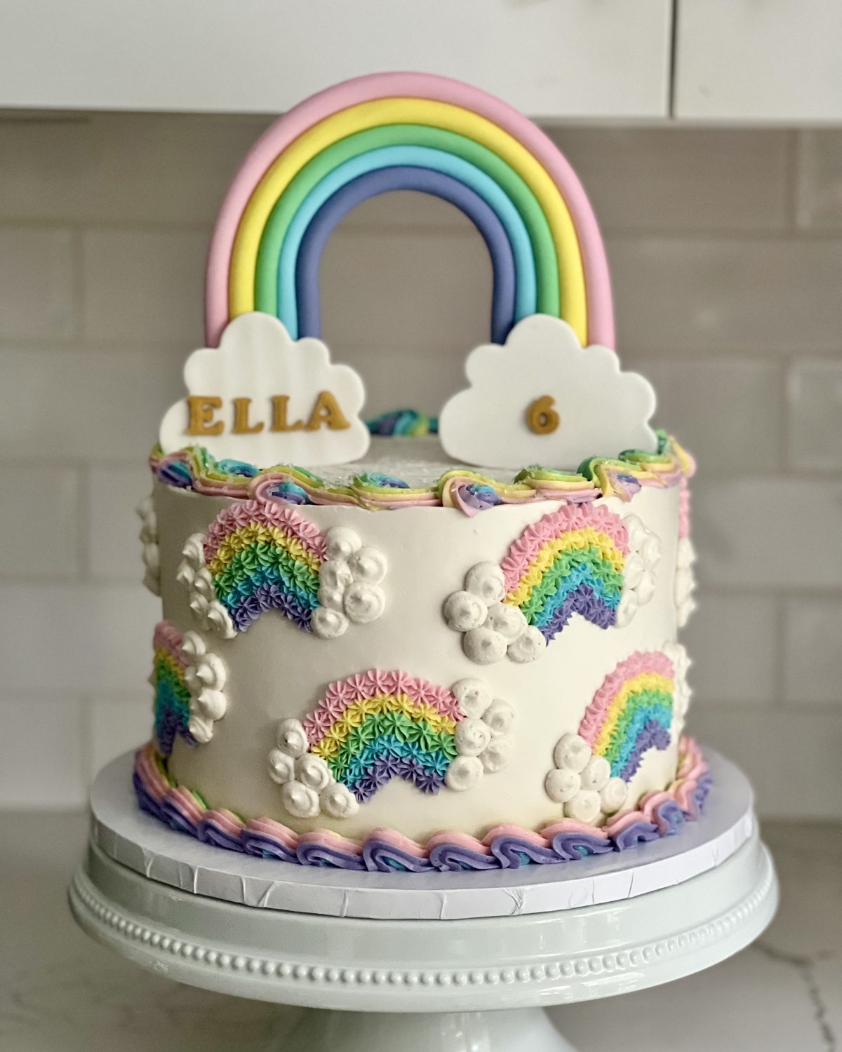 Rainbow first birthday cake with buttercream rainbows
